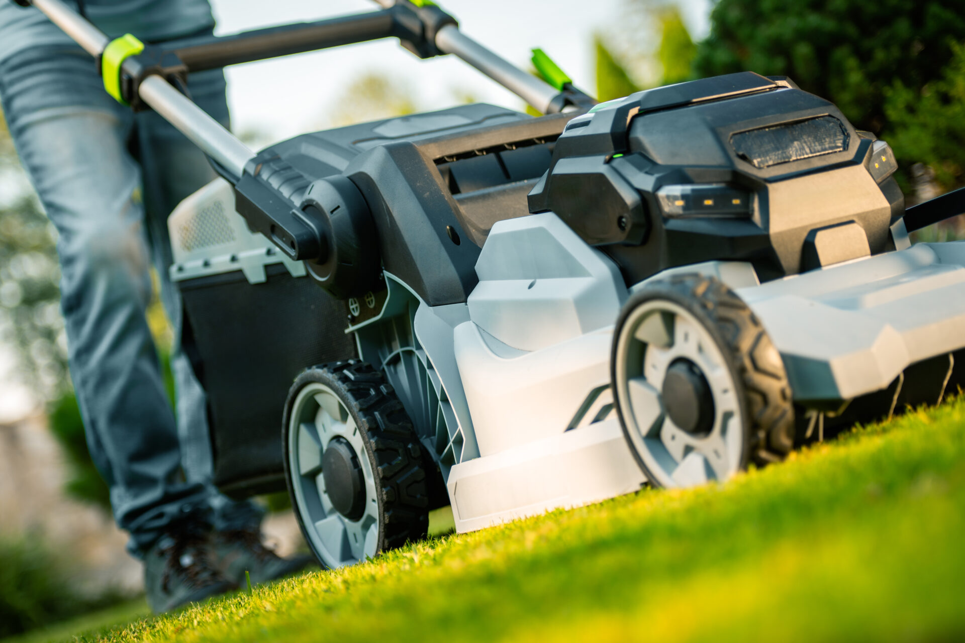 Lawn Maintenance in Progress at a Residential Yard With a Modern Lawn Mower in Use on a Sunny Afternoon